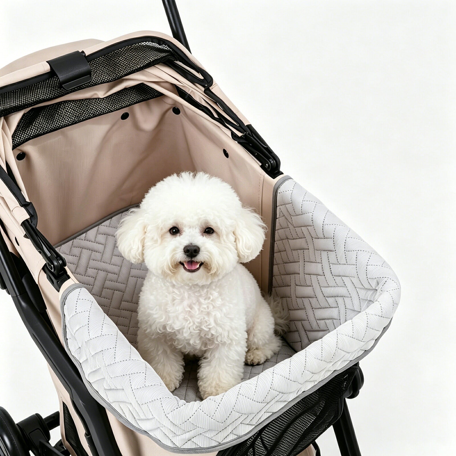 Small white dog sitting in a quilted DearPet stroller liner